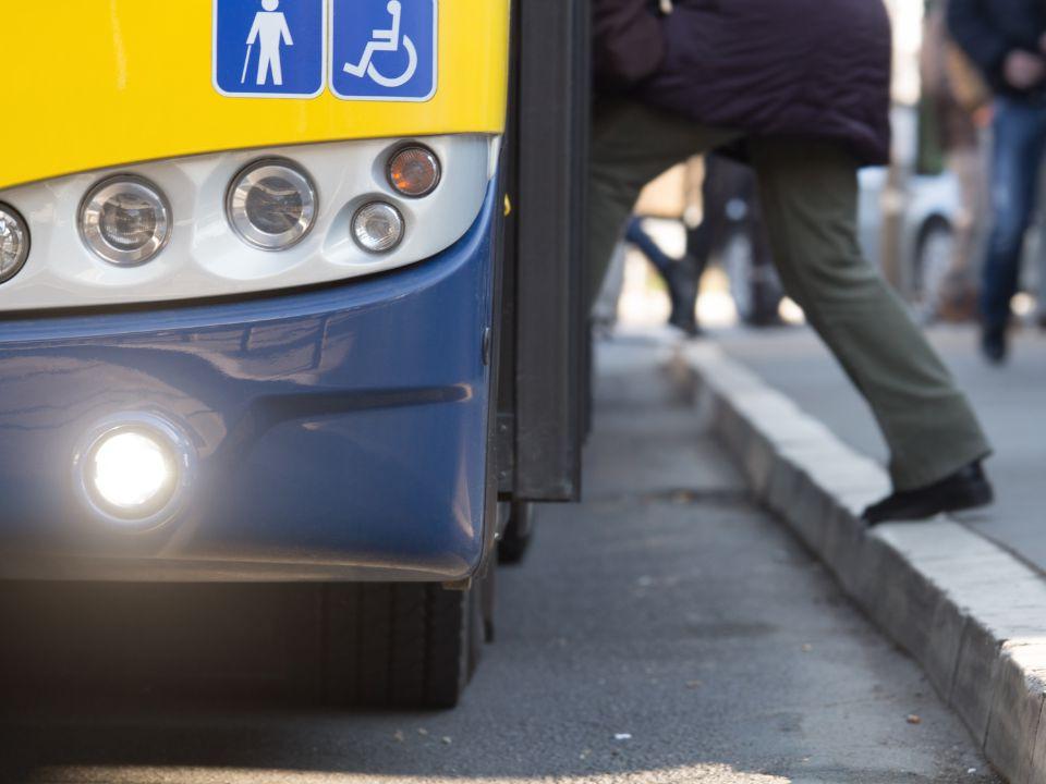 Close up of someone stepping onto a bus